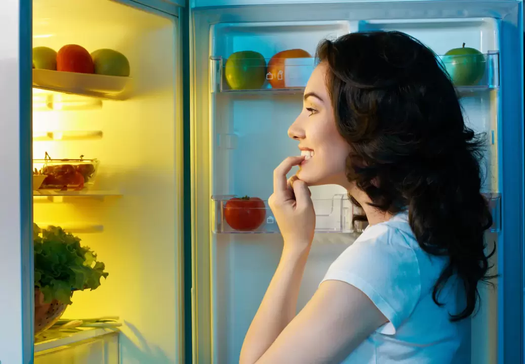 girl looking at refrigerator during rapid weight loss